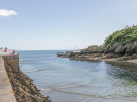 A view of the coastline with water and a pier at The Old Dairy near Liskeard