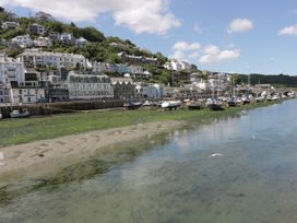 A view of boats and houses along a river at The Old Dairy near Liskeard