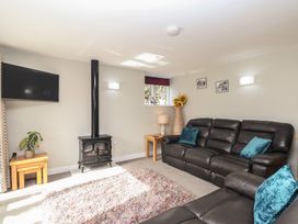 A living room with a television and sofa at The Old Dairy near Liskeard
