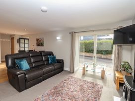 A living room with a sofa and coffee table at The Old Dairy near Liskeard