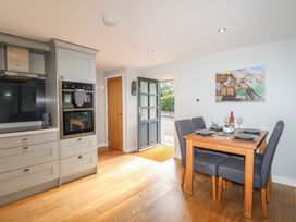 A kitchen with dining table and chairs at The Old Dairy near Liskeard