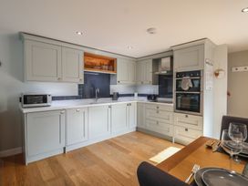 A kitchen with cabinets and appliances at The Old Dairy near Liskeard