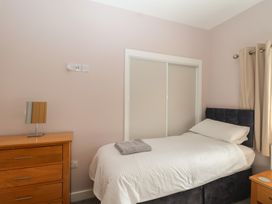 A bedroom with a bed and a dresser at The Old Dairy near Liskeard
