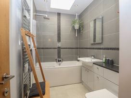 A bathroom with a bathtub and sink at The Old Dairy near Liskeard