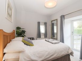 A bedroom with a bed and a window at The Old Dairy near Liskeard