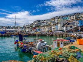 A harbor with boats and fishing nets at Greenswood Mews in Brixham