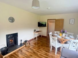 A dining room with a table and chairs at Saddleback Bungalow in Llandrindod Wells