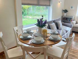 A dining table set with plates and glasses at Saddleback Bungalow in Llandrindod Wells