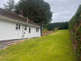 A bungalow with a garden and pathway at Saddleback Bungalow Llandrindod Wells