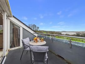 A balcony with a table and chairs at Apartment Sleeps 4 Enclosed Garden Pets Welcome in Flushing