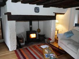 A living room with a fireplace and sofa at the property in the location