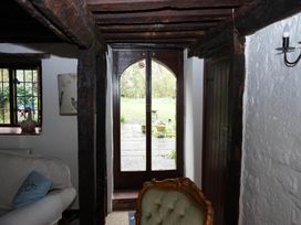 A living room with a window and door leading to the garden at the property in 