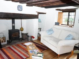 A living room with a couch and wood stove at The Old Barn in Manchester