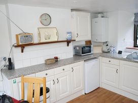 A kitchen with a microwave and refrigerator at The Old Barn in Manchester