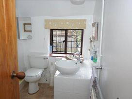 A bathroom with a toilet and wash basin at The Old Barn in Manchester