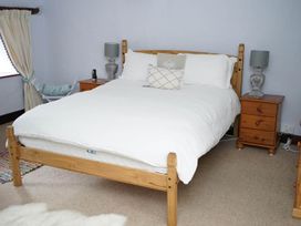 A bedroom with a bed and two nightstands at the property