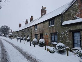A row of houses covered in snow along a road