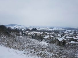A view of houses and hills covered in snow