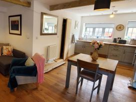A living room with a sofa and dining table at 3 Bedroom Cottage Hot Tub Garden Parking Dunkeswell