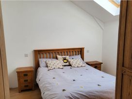 A bedroom with a bed and nightstands at 3 Bedroom Cottage Hot Tub Garden Parking Dunkeswell