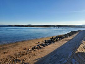 A view of a beach with water and rocks at 3 Bedroom Cottage Hot Tub Garden Parking Dunkeswell