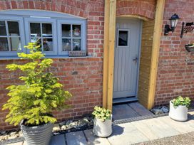 An entryway with a door and plants at Piglet Cottage in Dunkeswell