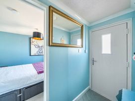 A bedroom with a door and mirror at the property