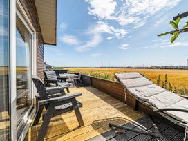 A deck with seating and a view at the property location