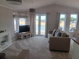 A living room with a television and sofa at Pet Friendly 2Bed Luxury Lodge in Routh HotTub near Heron Lakes Luxury Lodge Park