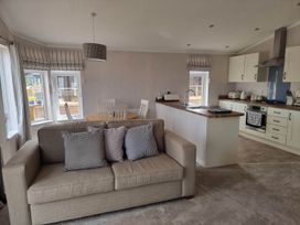 A living room with a sofa, table and chairs at Pet Friendly 2Bed Luxury Lodge in Routh HotTub Heron Lakes Luxury Lodge Park near Beverley