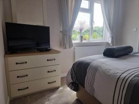 A bedroom with a television and dresser at Pet Friendly 2Bed Luxury Lodge in Routh HotTub near Heron Lakes Luxury Lodge Park
