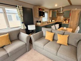 A living room with a kitchen counter and seating area at Vintage 121 Southview Holiday Park Skegness
