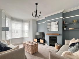A living room with a coffee table and a television at 4 Bed House Sleeps 8 Garden Pets Near Beach Llandudno