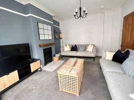 A living room with a sofa and coffee table at 4 Bed House Sleeps 8 Garden Pets Near Beach Llandudno