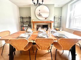 A dining room with a large table and chairs at 4 Bed House Sleeps 8 Garden Pets Near Beach in Llandudno