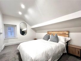 A bedroom with a bed and window at 4 Bed House Sleeps 8 Garden Pets Near Beach Llandudno