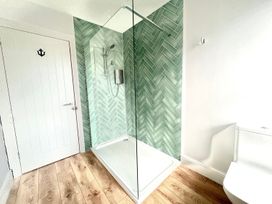 A bathroom with shower and toilet at 4 Bed House Sleeps 8 Garden Pets Near Beach Llandudno