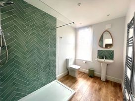 A bathroom with a shower and sink at 4 Bed House Sleeps 8 Garden Pets Near Beach Llandudno