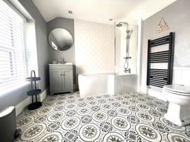 A bathroom with shower and bathtub at 4 Bed House Sleeps 8 Garden Pets Near Beach Llandudno