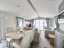 A living room with a table and chairs at Primrose Valley 3Bed Caravan Sleeps 8 Pets Ok Primrose Valley