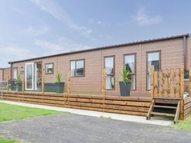 A deck with planter and steps at Boutique lodge with hot tub sleeps 6 in Bridlington