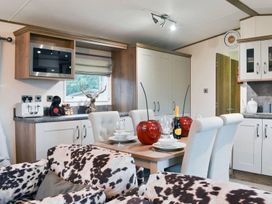 A kitchen with a dining area at Boutique lodge with hot tub sleeps 6 in Bridlington
