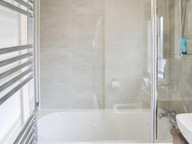 A bathroom with a shower and bath tub at Boutique lodge with hot tub sleeps 6 Bridlington