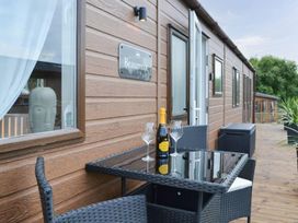 An outdoor seating area with a table and champagne at Beaumont in Bridlington