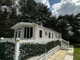 A cabin exterior with a staircase and patio at 2Bed Ringwood Cabin incl Park Pass SelfCheckin Saint Leonards near Ferndown