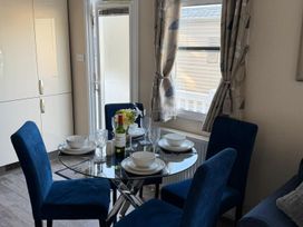 A dining area with a table set for dinner at 2Bed Ringwood Cabin incl Park Pass SelfCheckin in Saint Leonards near Ferndown