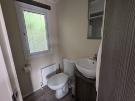A bathroom with a sink and toilet at 2Bed Ringwood Cabin incl Park Pass SelfCheckin in Saint Leonards near Ferndown