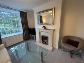 A living room with a fireplace and window at Charming 3Bed Cottage  Private Garden Parking in Torquay