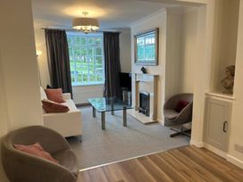 A living room with a sofa, coffee table, and fireplace at Charming 3Bed Cottage Private Garden Parking in Torquay