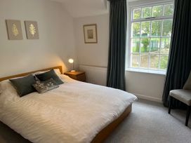 A bedroom with a bed and window at Charming 3Bed Cottage Private Garden Parking in Torquay